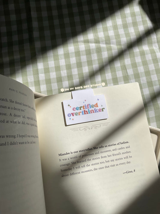 Magnetic bookmark with a rainbow text saying "Certified Overthinker" with cute stars around it
