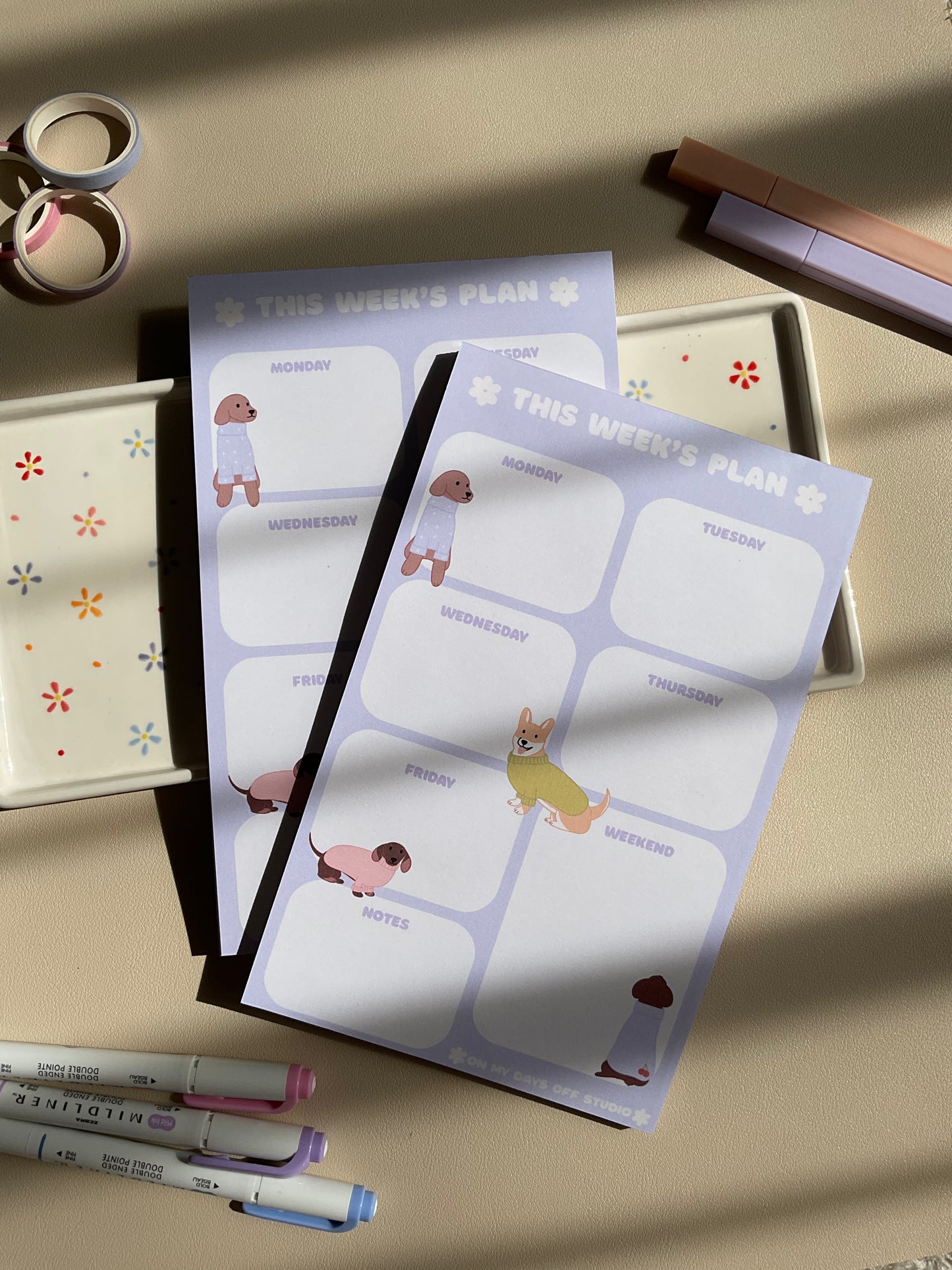 Weekly planner with a purple and dog theme. It has sections for every day of the week and for notes.