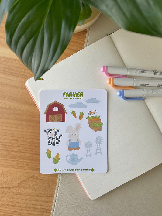 This stationery sticker sheet features a farm theme and has 13 colorful illustrations. These stickers include illustrations like a barn house, clouds, carrots, a bunny farmer, and cow. These glossy stickers are perfect for planners and bullet journals. 