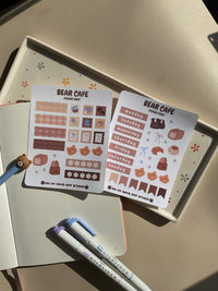 Set of 2 sticker sheets for a journal spread or planner spread. This set is a bear cafe theme. One sticker sheet has decor stickers to help bring color and life. The second sticker sheet has stickers for each day of the week and some additional decor stickers to help set up sections for your journal page.