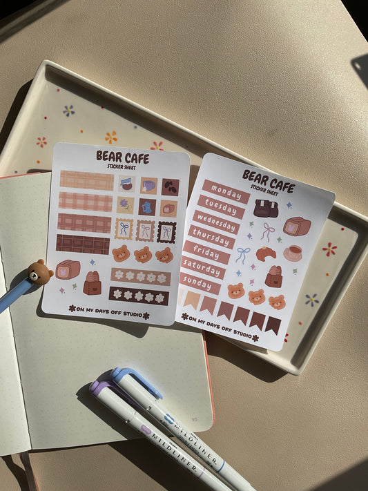 Set of 2 sticker sheets for a journal spread or planner spread. This set is a bear cafe theme. One sticker sheet has decor stickers to help bring color and life. The second sticker sheet has stickers for each day of the week and some additional decor stickers to help set up sections for your journal page.