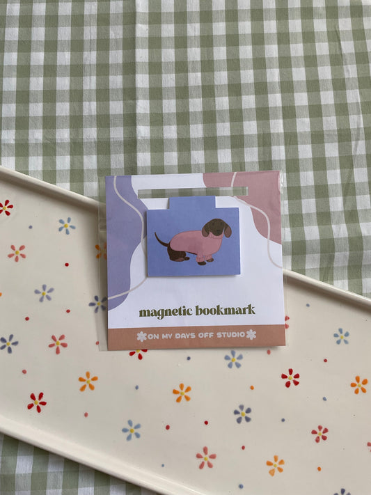 Dachshund wearing a pink sweater magnetic bookmark