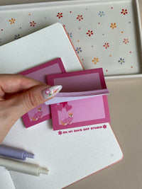 Pink sticky notes with a light pink background and darker pink boarder. There is a cute corgi wearing a sweater and carrying 3 heart balloons in the bottom left corner.