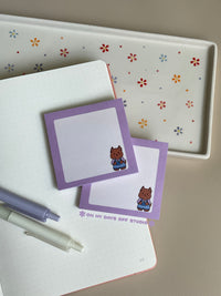 Cute grid background sticky notes with a light purple boarder and adorable character in the right corner. The character is a original with a painters overalls on