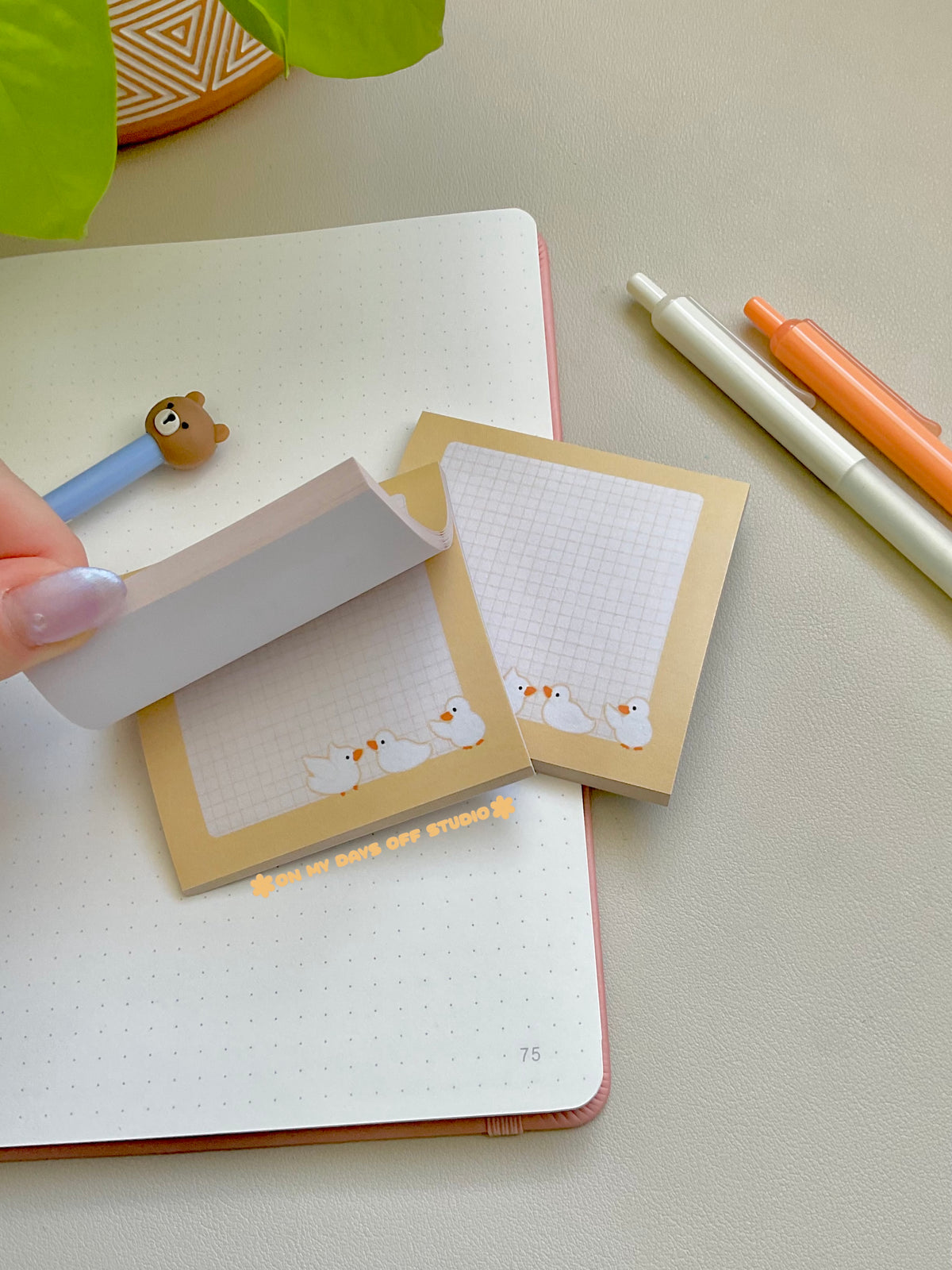 Cute yellow sticky notes with a grid background and 3 yellow ducks in the bottom right corner