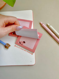 Cute pink sticky notes with a grid background and an adorable dachshund wearing a pink sweater in the bottom left corner