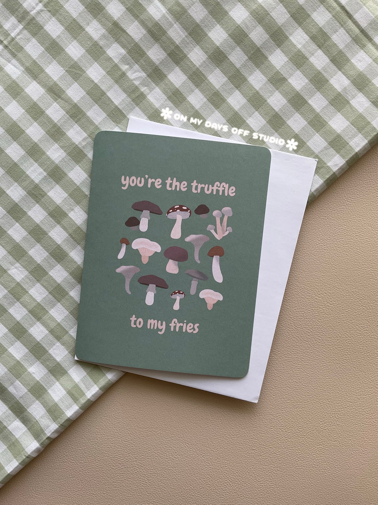 Green greeting card with a funny mushroom theme. The card says "You're the truffle to my fries" and has whimsical illustrations of different forest mushrooms