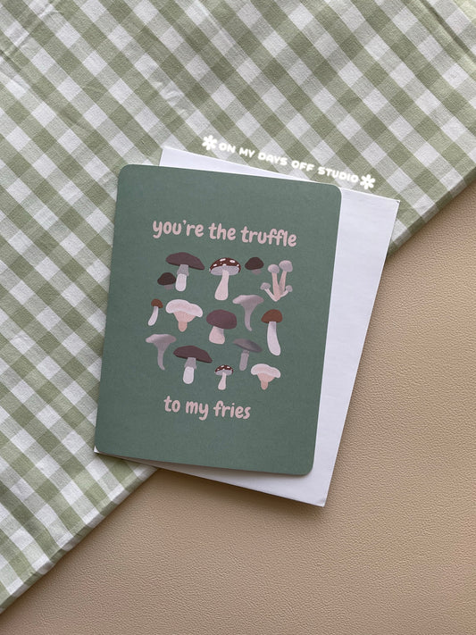 Green greeting card with a funny mushroom theme. The card says "You're the truffle to my fries" and has whimsical illustrations of different forest mushrooms