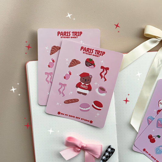 This stationery sticker sheet features a Paris Trip theme and has 10 colorful illustrations. This includes a bear in a Paris sweater, bows, chocolate dipped strawberries, croissant, perfume, macaroons and a french baguette. These glossy stickers are perfect for planners and bullet journals.&nbsp;