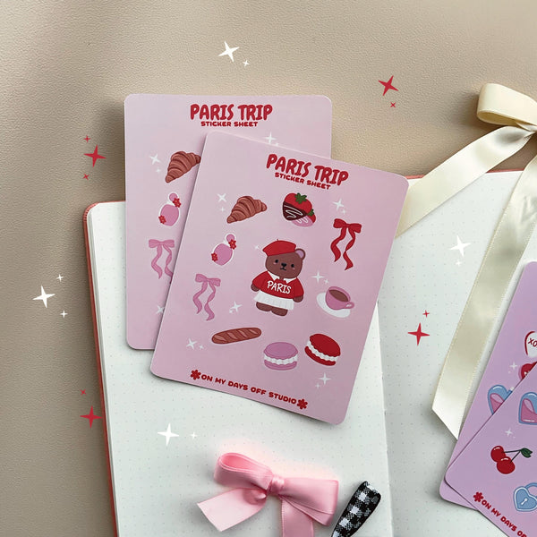 This stationery sticker sheet features a Paris Trip theme and has 10 colorful illustrations. This includes a bear in a Paris sweater, bows, chocolate dipped strawberries, croissant, perfume, macaroons and a french baguette. These glossy stickers are perfect for planners and bullet journals.&nbsp;