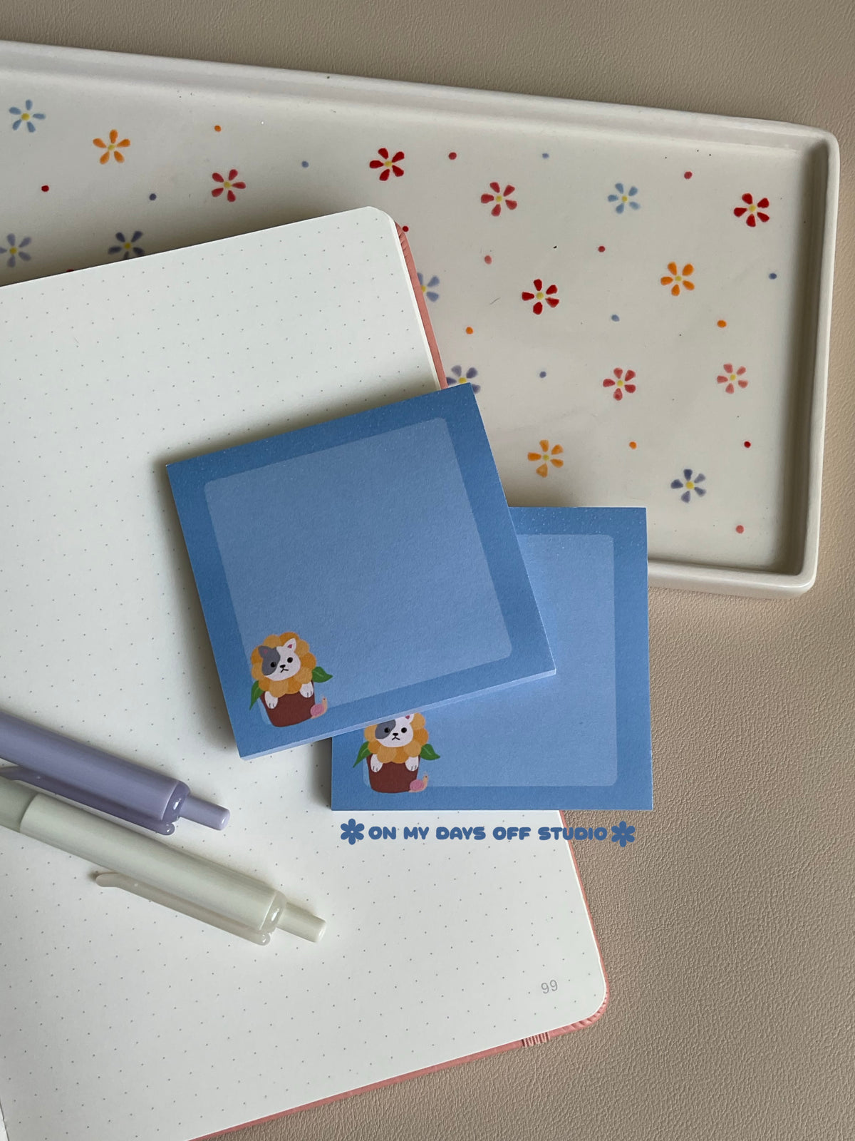 Cute blue sticky note with a adorable cat in a sunflower flower pot in the left bottom corner