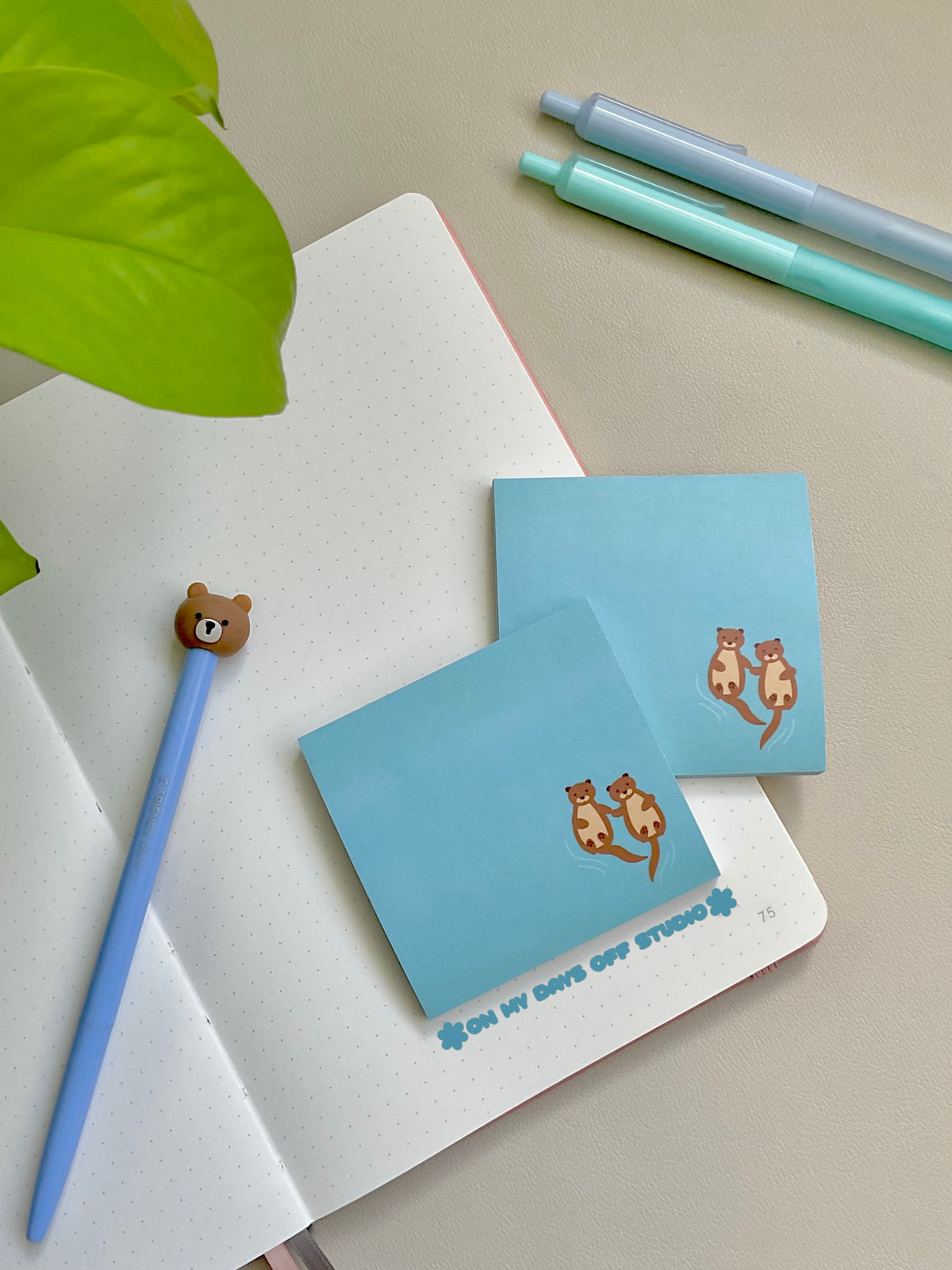 Blue sticky notes with two cute otters holding hands in the bottom right corner