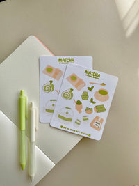 This stationery sticker sheet features a green tea theme and has 13 colorful illustrations. These illustrations include matcha cup, green tea cake roll, matcha leaves, green tea ice cream and other green tea good items.These glossy stickers are perfect for planners and bullet journals.&nbsp;