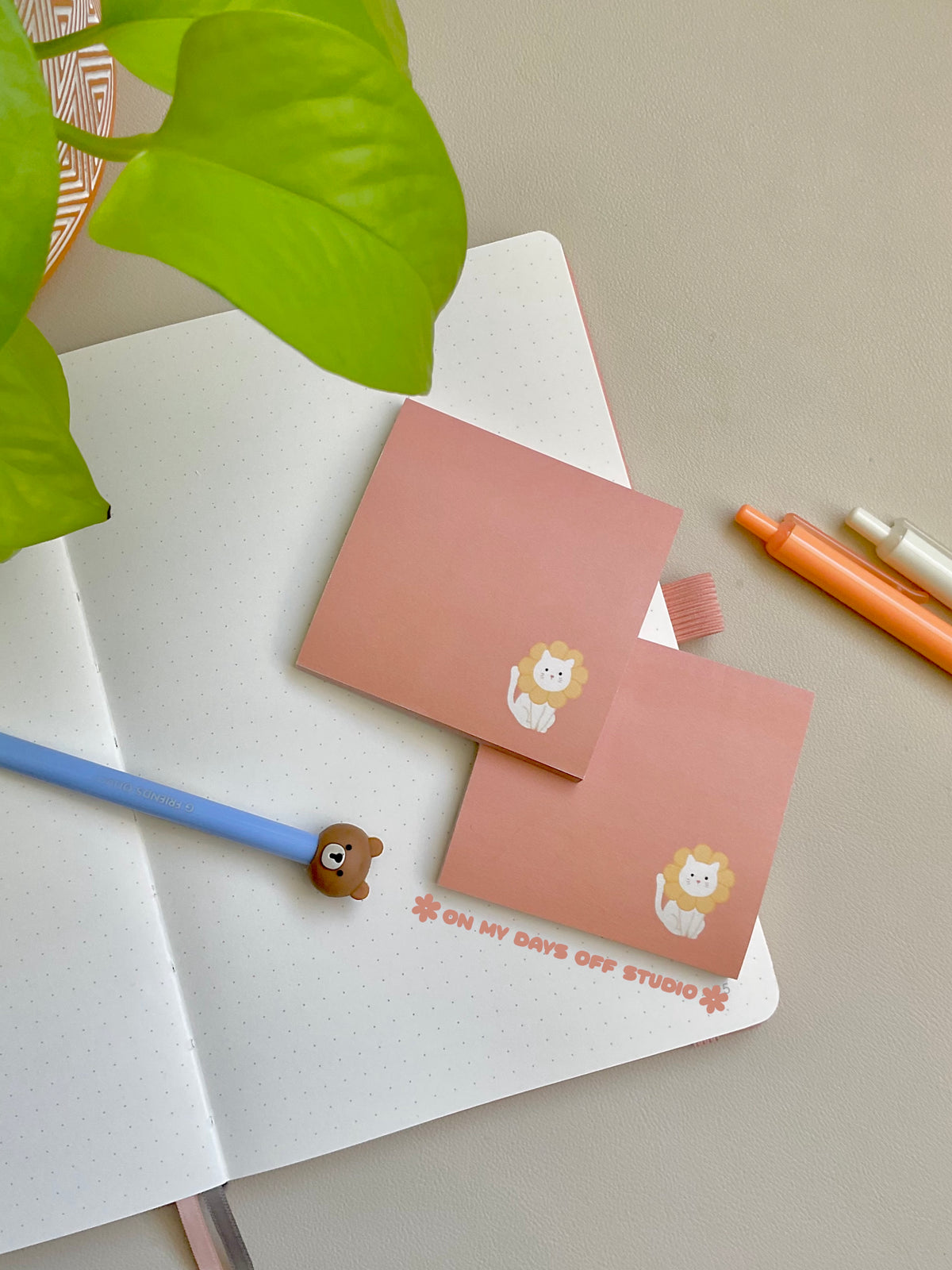 peach colored sticky notes with a white cat in the right corner wearing flower petals around it's head