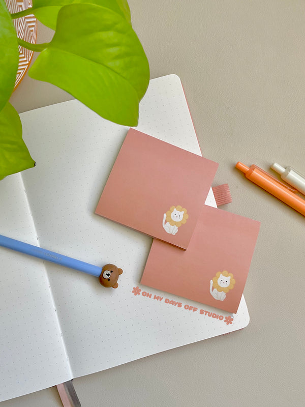 peach colored sticky notes with a white cat in the right corner wearing flower petals around it's head