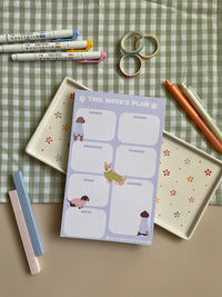 Weekly planner with a purple and dog theme. It has sections for every day of the week and for notes.