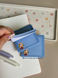 Cute blue sticky note with a adorable cat in a sunflower flower pot in the left bottom corner