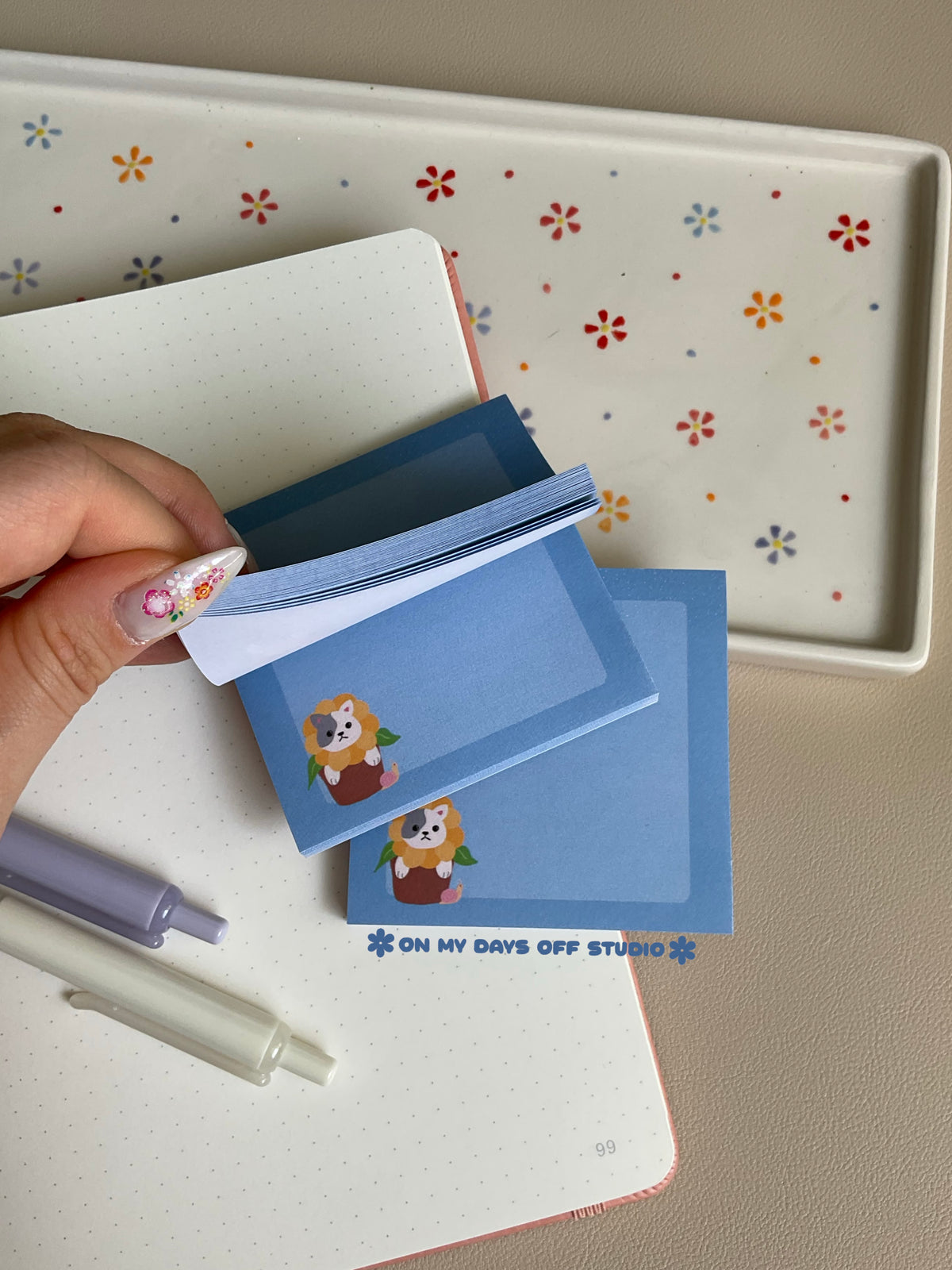 Cute blue sticky note with a adorable cat in a sunflower flower pot in the left bottom corner