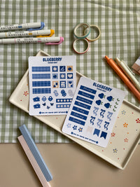 Sticker sheet set with a cute bluberry theme. One sticker sheet has stickers for each day of the week and decor stickers to help bring color to your planner spread. The second sticker sheet has more decor stickers to help create sections to your journal spread.
