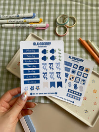 Sticker sheet set with a cute bluberry theme. One sticker sheet has stickers for each day of the week and decor stickers to help bring color to your planner spread. The second sticker sheet has more decor stickers to help create sections to your journal spread.