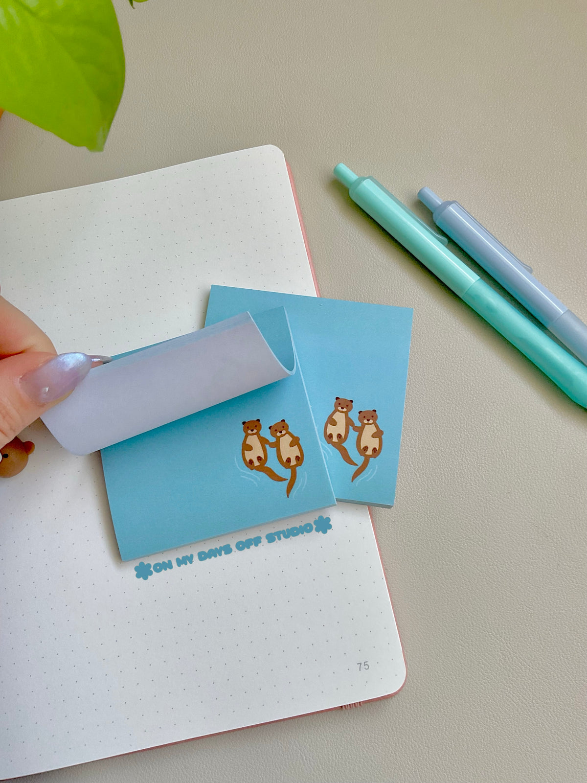 Blue sticky notes with two cute otters holding hands in the bottom right corner