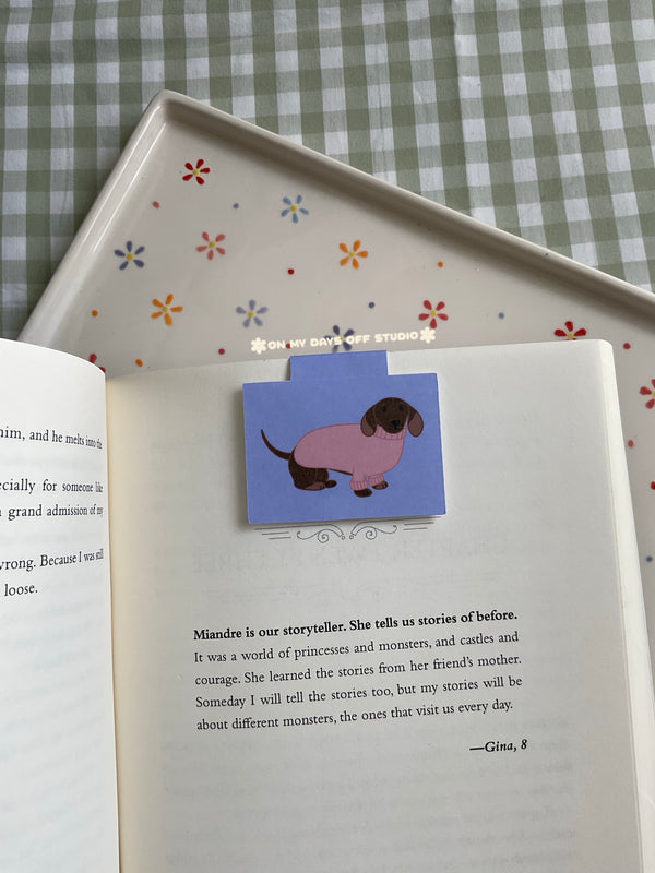 Dachshund wearing a pink sweater magnetic bookmark