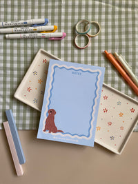 Cute light blue notepad with a retro wavy boarder in white and blue. A cute gold retriever or lab sitting in the bottom left corner