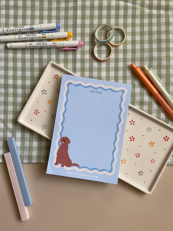 Cute light blue notepad with a retro wavy boarder in white and blue. A cute gold retriever or lab sitting in the bottom left corner