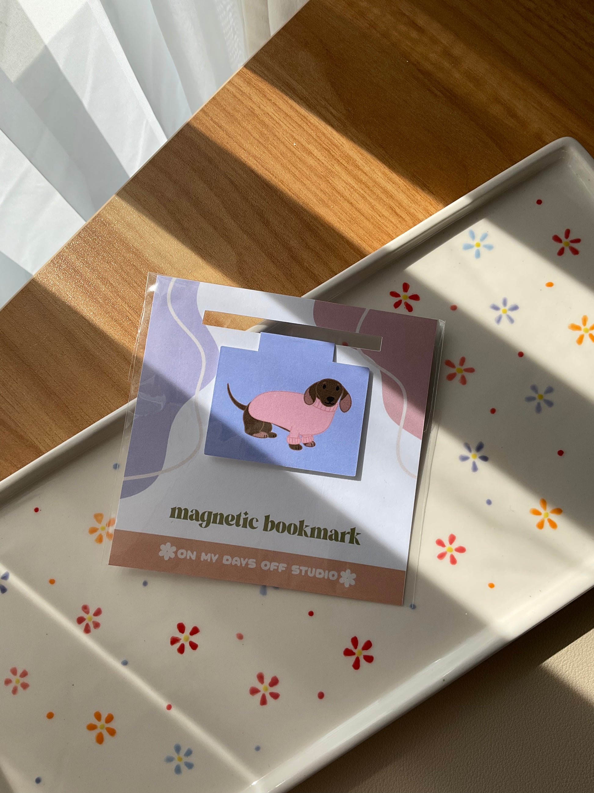 Dachshund wearing a pink sweater magnetic bookmark