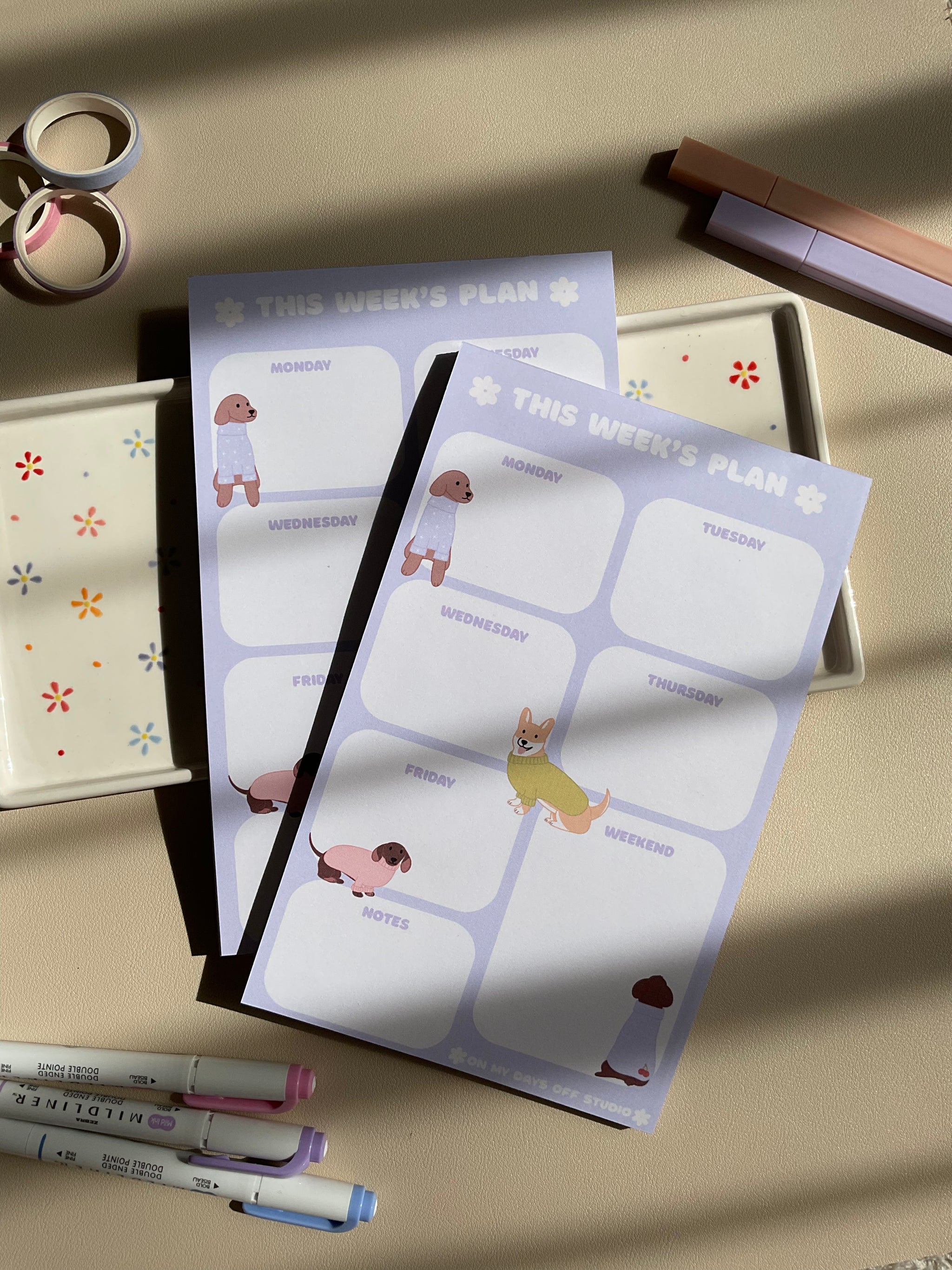 Weekly planner with a purple and dog theme. It has sections for every day of the week and for notes.