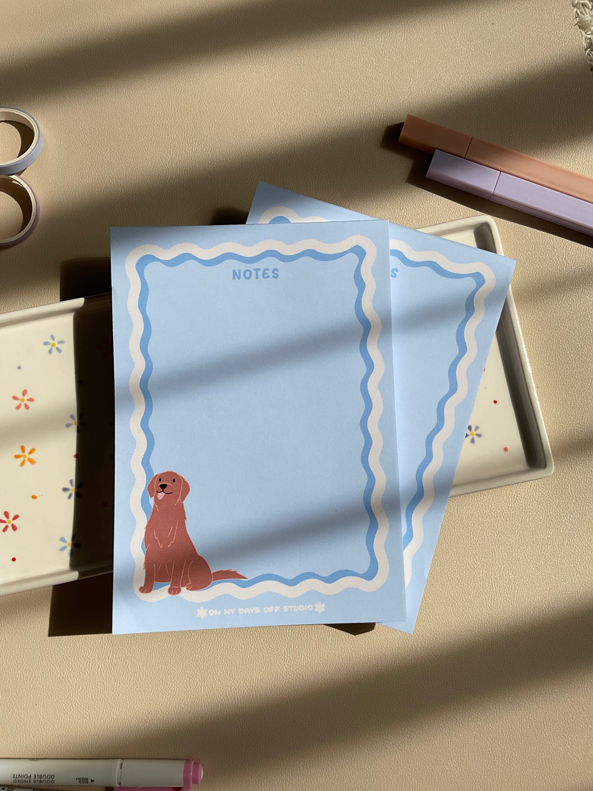 Cute light blue notepad with a retro wavy boarder in white and blue. A cute gold retriever or lab sitting in the bottom left corner