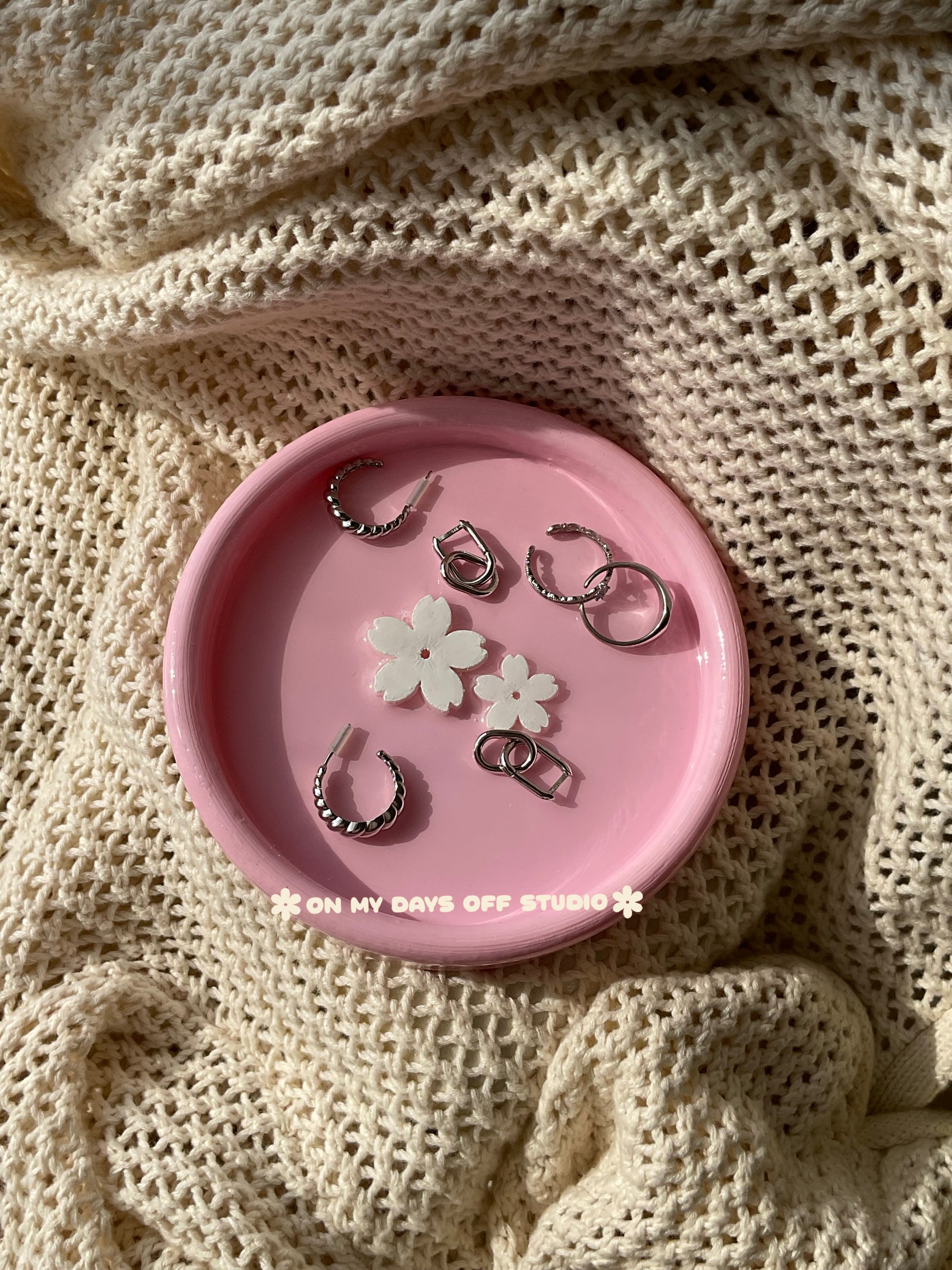 Pink jewelry dish or trinket holder with raised cherry blossom design