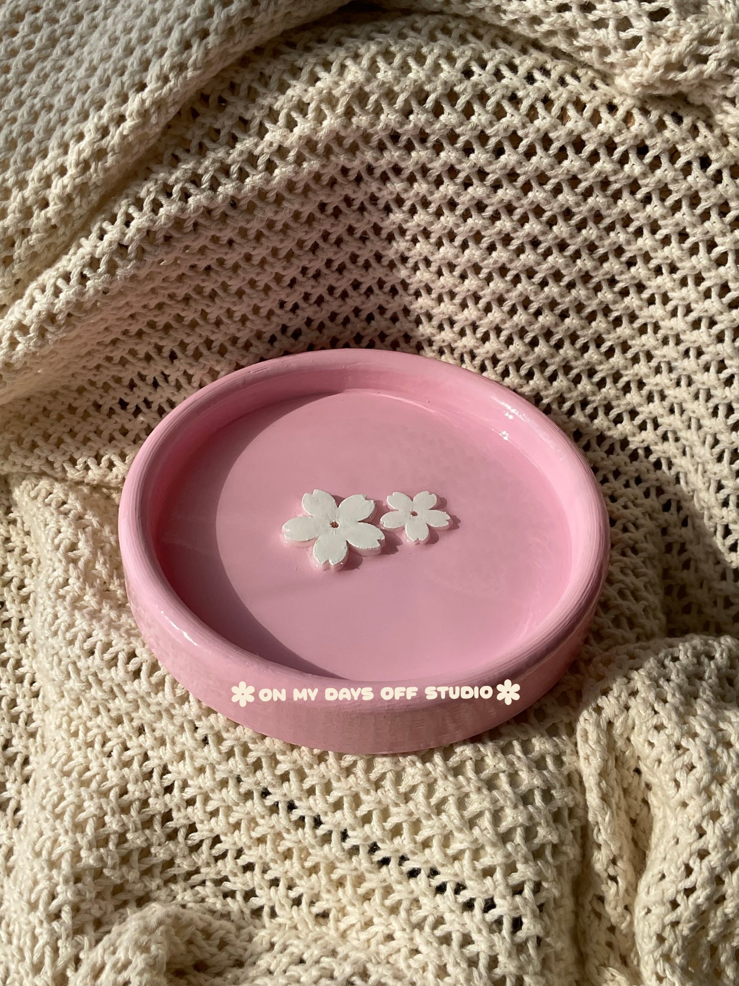 Pink jewelry dish or trinket holder with raised cherry blossom design