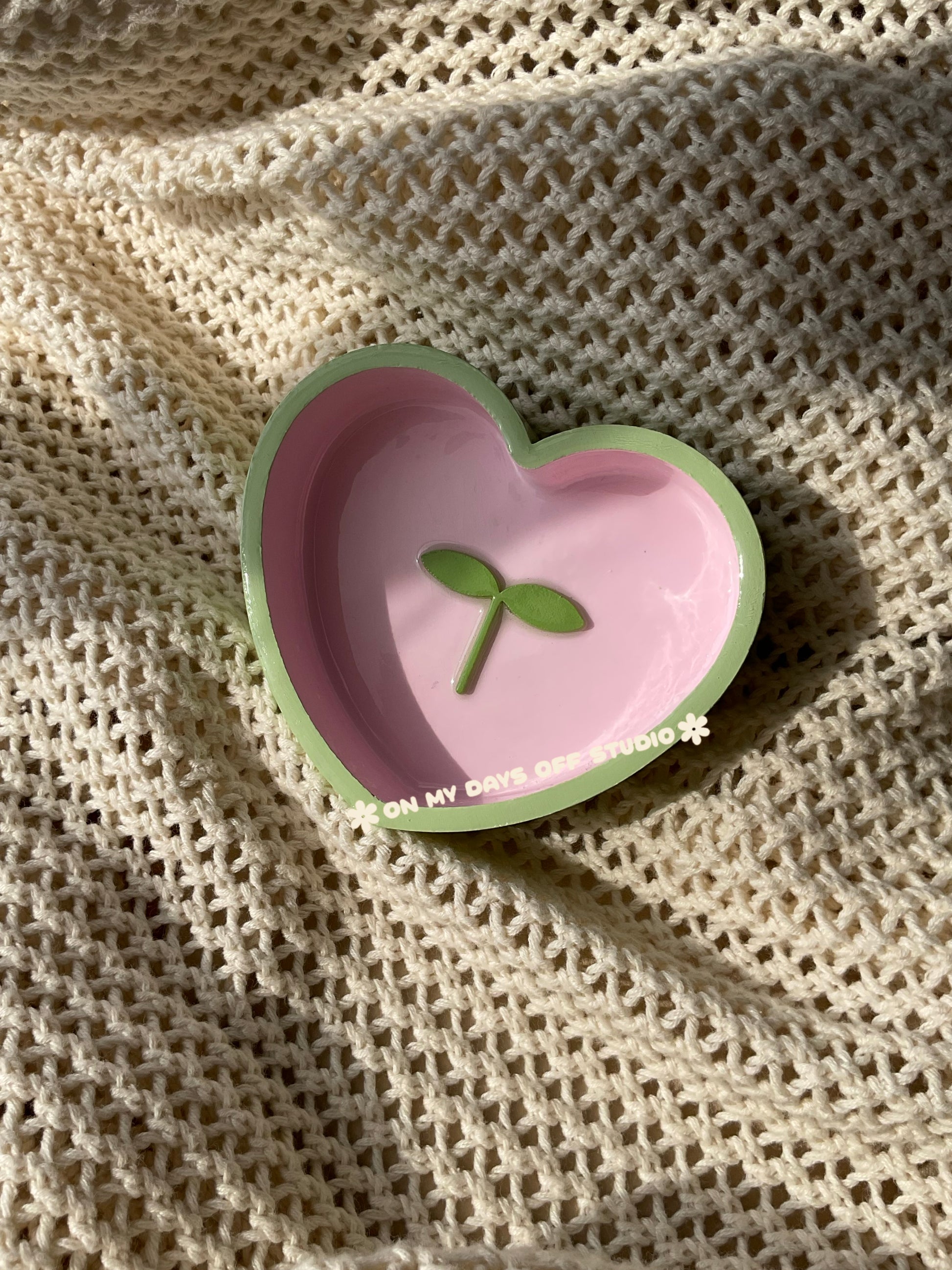 Heart-shaped pink jewelry dish with green edge & green 3D sprout in the center