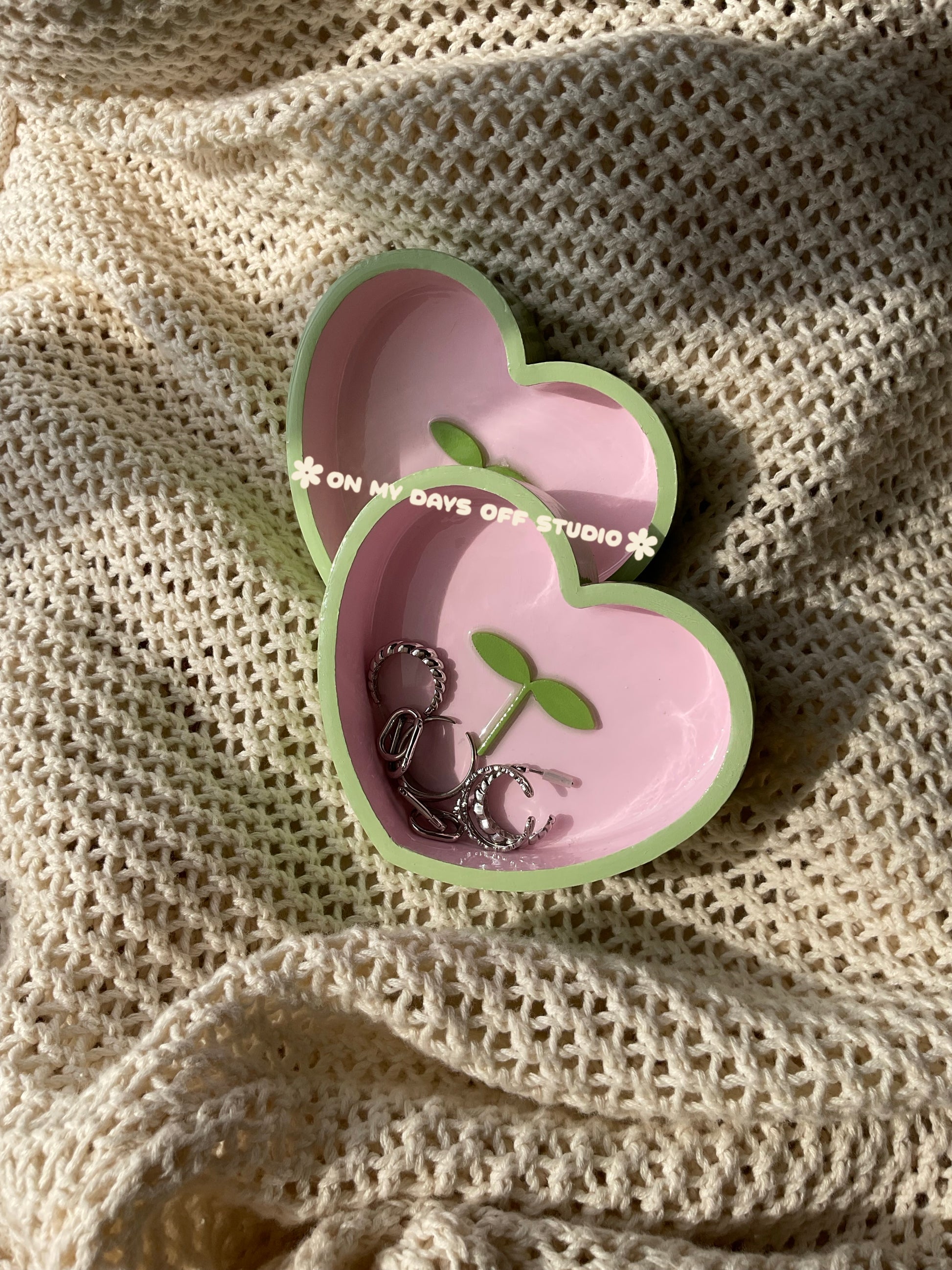 Heart-shaped pink jewelry dish with green edge & green 3D sprout in the center